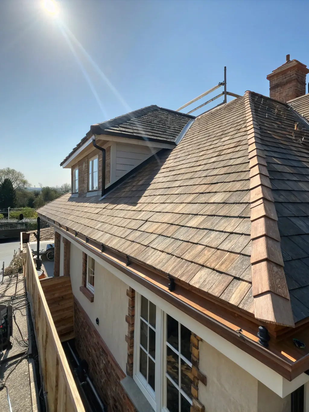 A photograph of a professionally installed roofing system on a residential home, highlighting the quality of materials and workmanship by D&C PROJECTS INC.