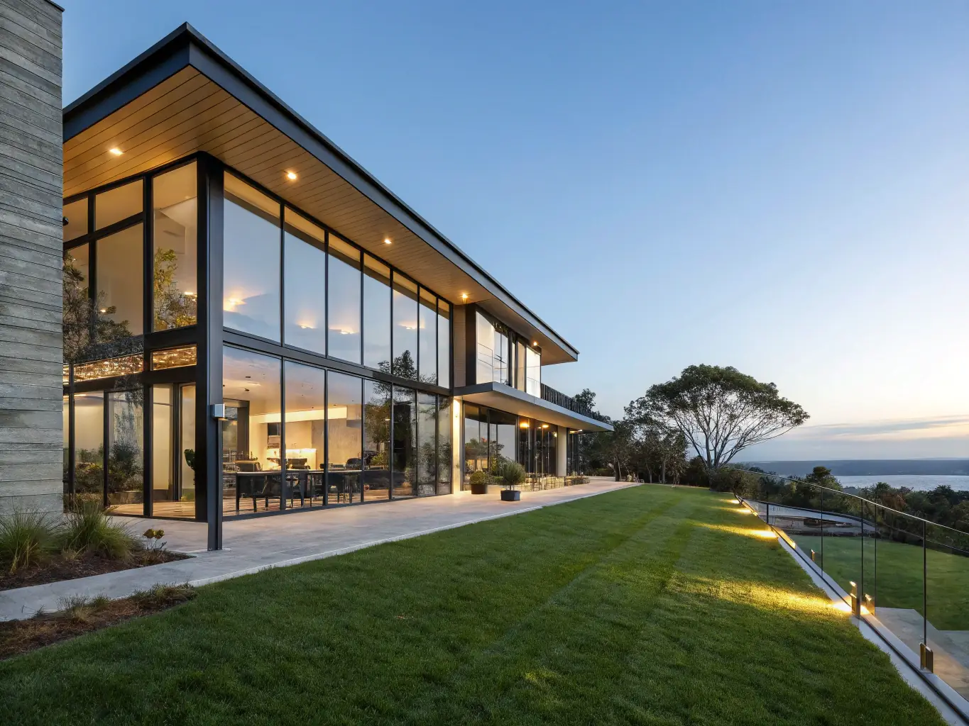 A beautifully constructed custom home showcasing modern architecture and design, set against a clear blue sky.